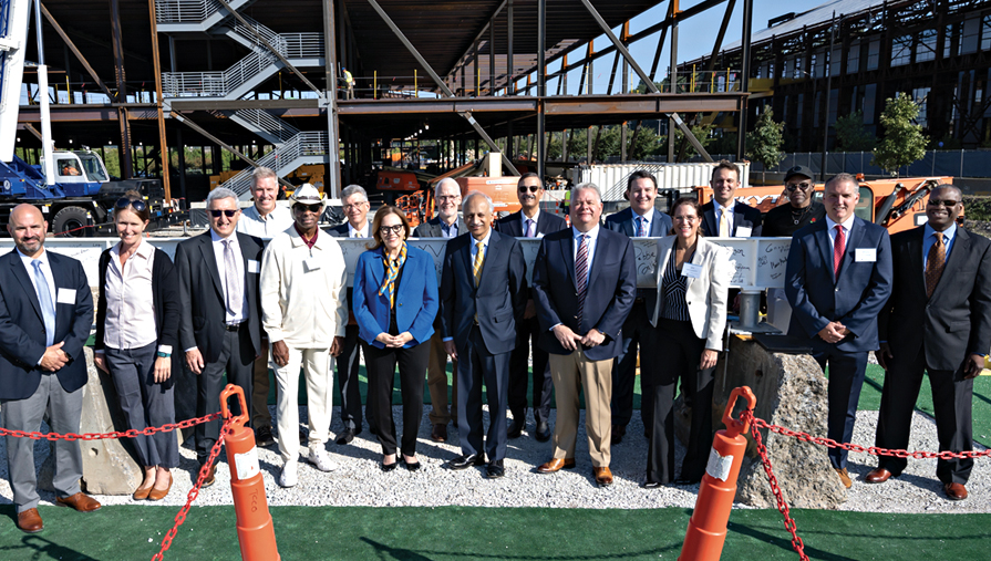 Group gather in front of contruction of the Pitt BioForge building